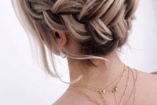 a braided halo low updo with a volume on top, some waves down is a lovely idea for a boho look at the party