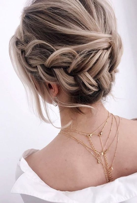 a braided halo low updo with a volume on top, some waves down is a lovely idea for a boho look at the party