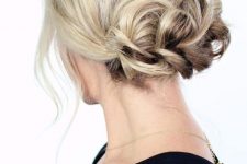 a braided low updo with some volume on top and some locks down is a chic and cool idea for any holiday party