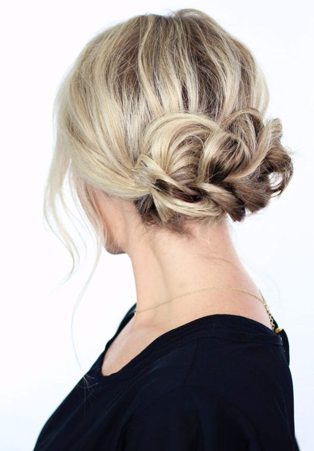 a braided low updo with some volume on top and some locks down is a chic and cool idea for any holiday party