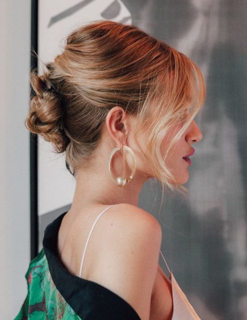 a braided updo with a bump on top and locks framing the face is a catchy and sexy idea for the holidays