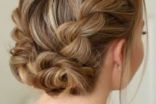 a braided updo with two twisted low buns and volume on top is a chic and stylish idea for a party look with a boho feel