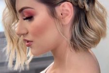 a catchy and stylish half updo with a loose braid on one side and waves down is a lovely solution for a cool and bold look