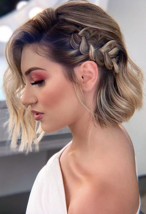 a catchy and stylish half updo with a loose braid on one side and waves down is a lovely solution for a cool and bold look