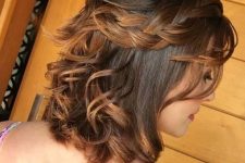 a catchy half updo with a bump on top and a loose braided halo plus some waves down is a cool and lovely idea