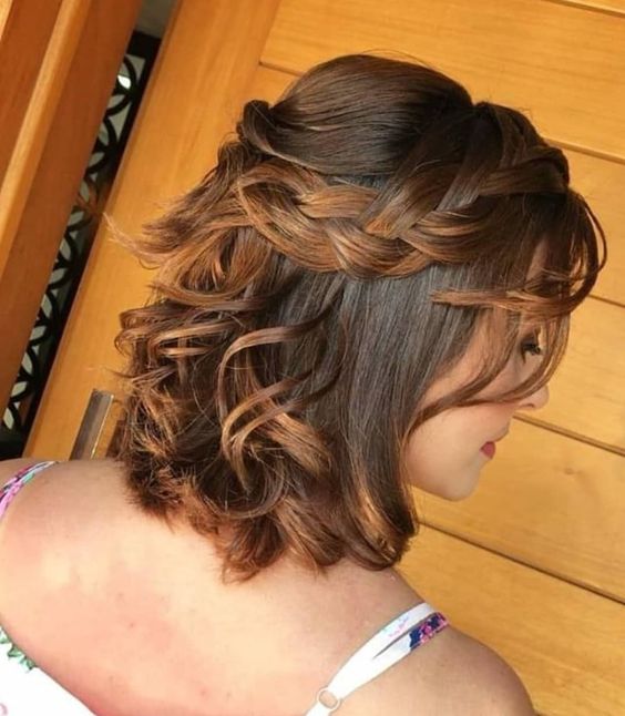 a catchy half updo with a bump on top and a loose braided halo plus some waves down is a cool and lovely idea