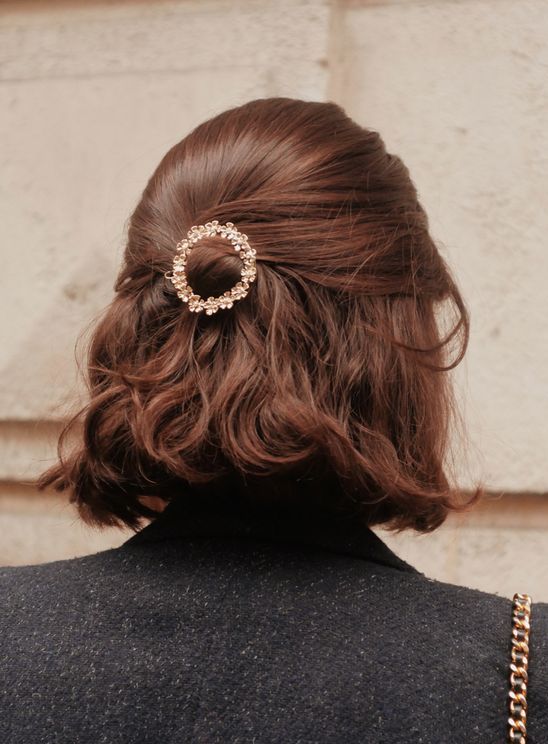 a chic and pretty half updo with a sleek top and waves down plus a beautiful embellished hair piece is a cool idea for a party