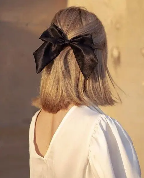 a classic half updo with some hair down and a black silk bow are a lovely combo for any look, it’s super stylish