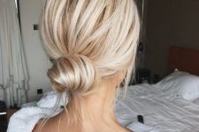a classic low bun with a volume on top and some locks down is a cool idea for a modern look