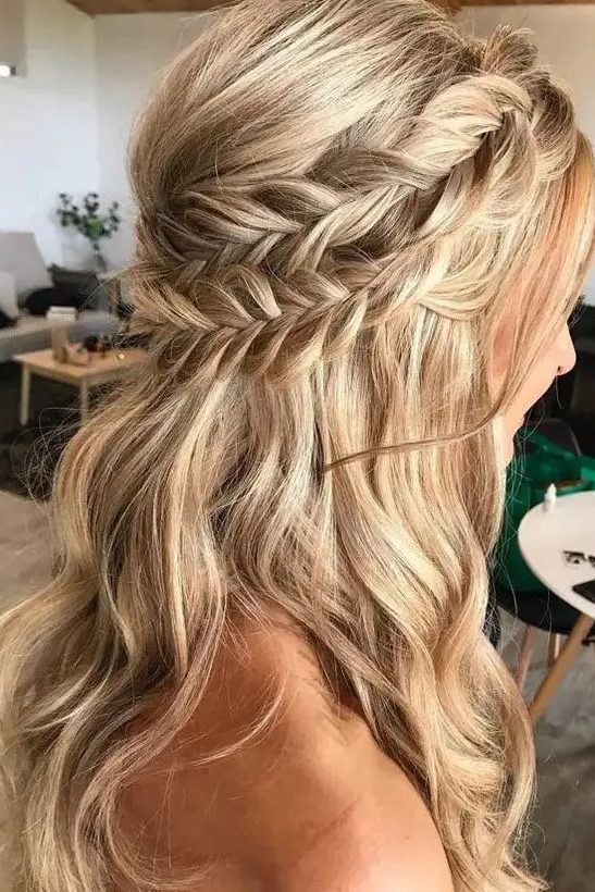 a classy boho half updo with a double braided halo and waves down plus a bump requires no accessories as it's gorgeous itself