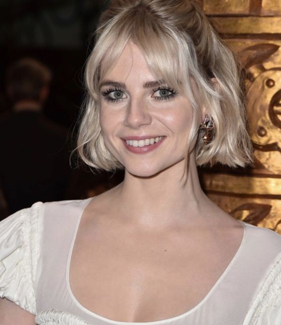 a classy half updo with face-framing bangs, waves and a bump on top is always a good idea