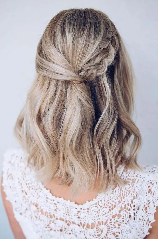 a cool blonde medium length half updo with a side braid and waves down is a stylish idea for a boho party look