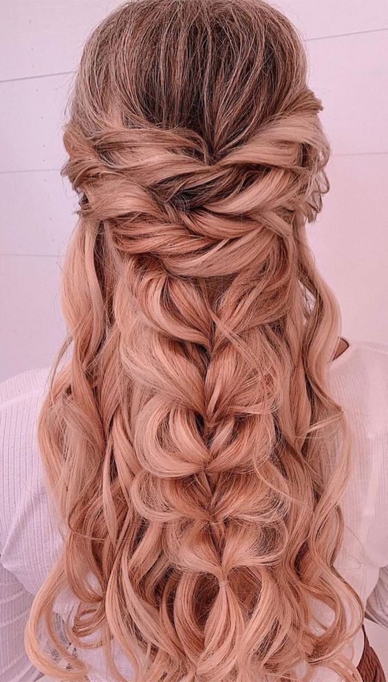 a gorgeous volumetric half updo with twists, a loose braid and waves down is a cool and catchy solution