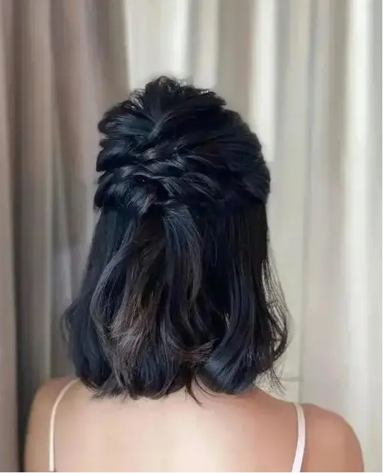 a half updo with twisted halos and a bump on top and some waves down is a cool idea for medium length hair