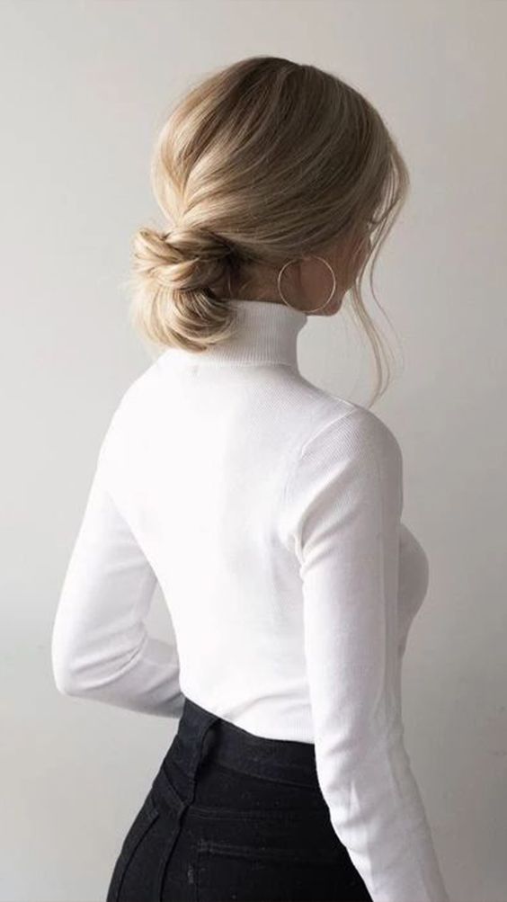 a knotted low bun with a volumetric top and face-framing hair is a cool and chic idea to rock and to try