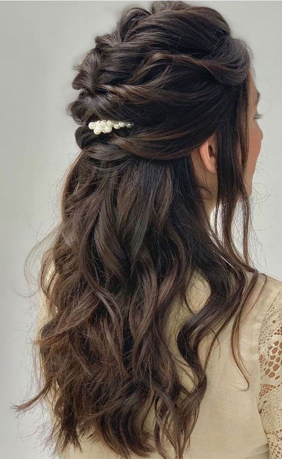a long hair half updo with a braided top, waves down and a pretty pearly hair pin is a cool and chic idea