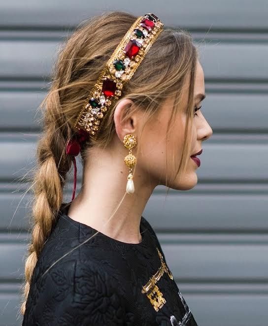 a long loose braid paired with a fantastic rhinestone tiara in Christmassy colors and statement earrings