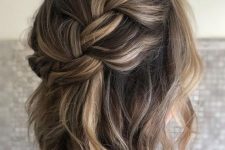 a loose braided halo half updo with waves and some volume is a chic and lovely idea for medium length hair