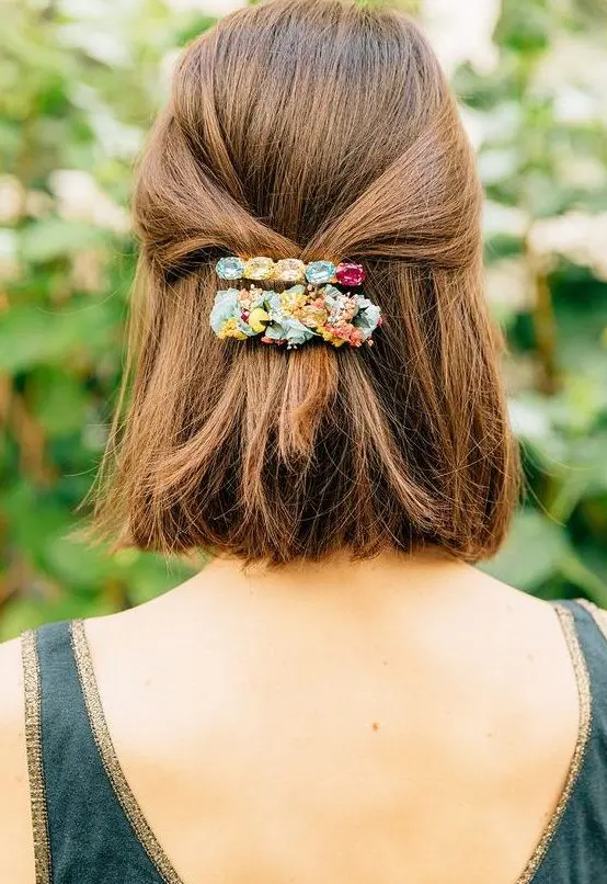 a lovely half updo with straight volumetric hair and colorful barrettes is a cool idea for holidays
