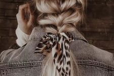 a lovely loose chunky braid with a ponytail, volume on top and a printed ribbon is a cool and easy hairstyle