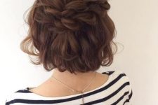 a messy and voluminous half updo with a loose double braid, a wavy top and waves down is a cool boho hairstyle