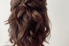a messy twisted and wavy half updo with waves on top and waves down is a relaxed and cute hairstyle for medium length hair