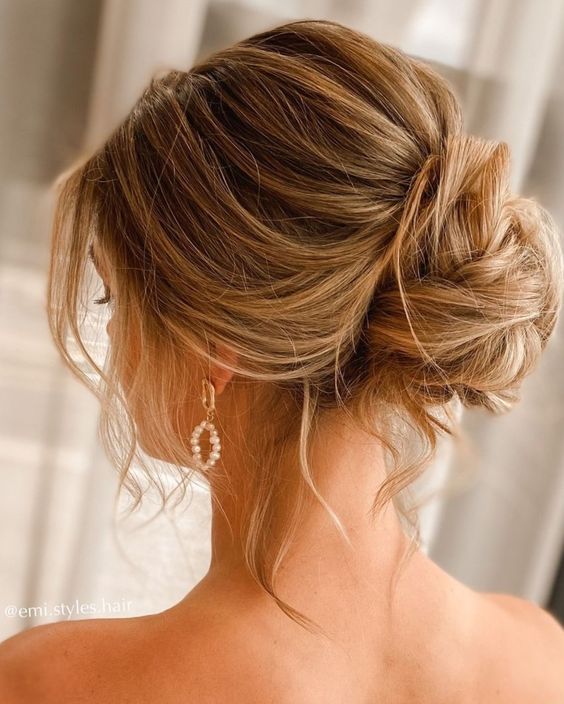 a messy twisted updo with a bun and a bump on top and some hair down is always a perfect solution for the holidays