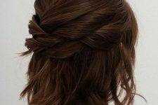 a modern half updo with several twists on top and a bump, with some waves down is a cool idea for a bridesmaid
