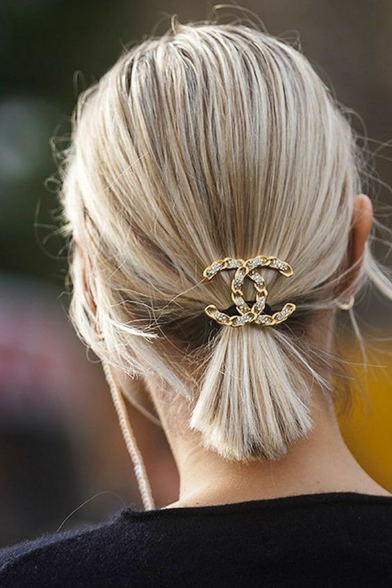 a perfect last-minute Christmas hairstyle for short hair, just a ponytail accented with a rhinstone logo hair piece