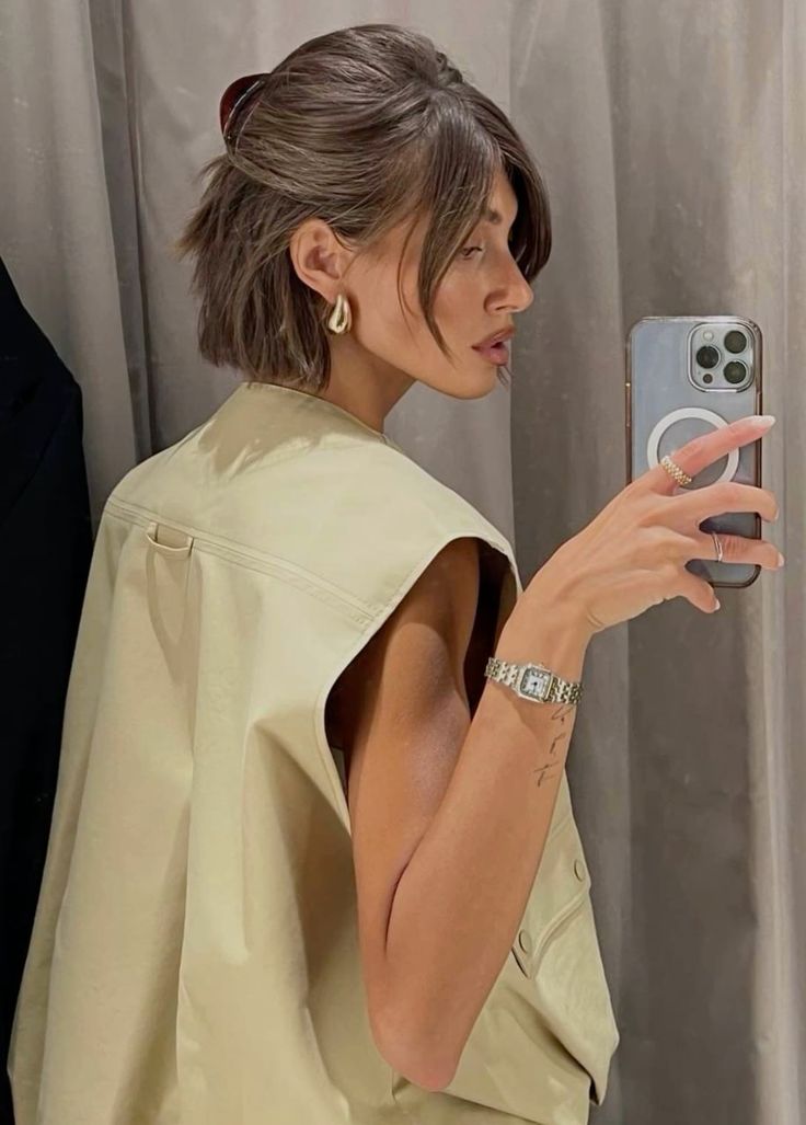 a pretty half updo with a bump on top, bangs framing the face and a midi bun are great for long bobs