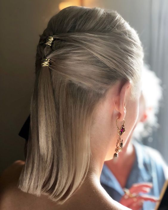 a pretty half updo with a midi ponytail and a bump on top, straight hair down and a gold accents is a lovely idea for a party