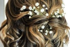 a pretty twisted half updo with waves and baby’s breath tucked in is a great idea for a boho or rustic look