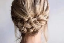 a rustic low updo with a double braid and some locks down is a stylish idea for a rustic or relaxed party look