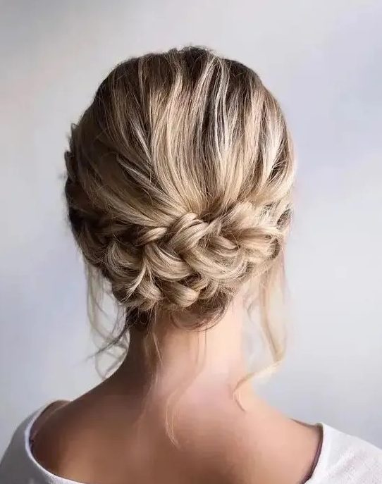 a rustic low updo with a double braid and some locks down is a stylish idea for a rustic or relaxed party look