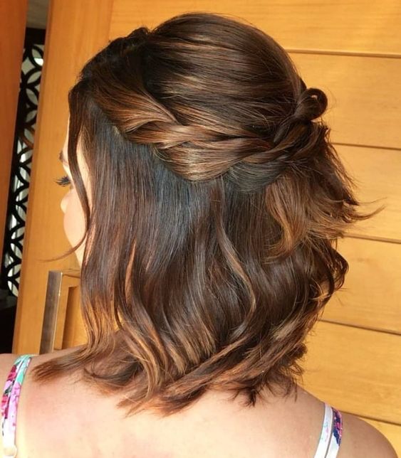 a simple and lovely half updo with a bump on top and a braided halo plus some hair down is a cool idea