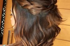 a simple and lovely half updo with a bump on top and a braided halo plus some hair down is a cool idea
