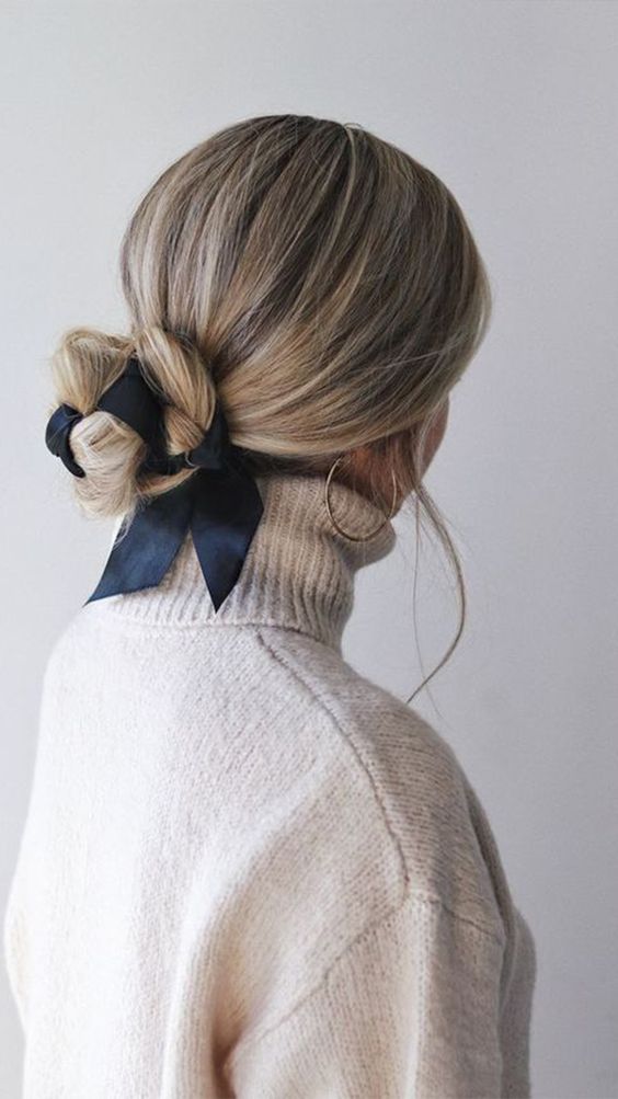 a simple and pretty woven low bun accented with a black ribbon looks very nice, cute and easy to realize