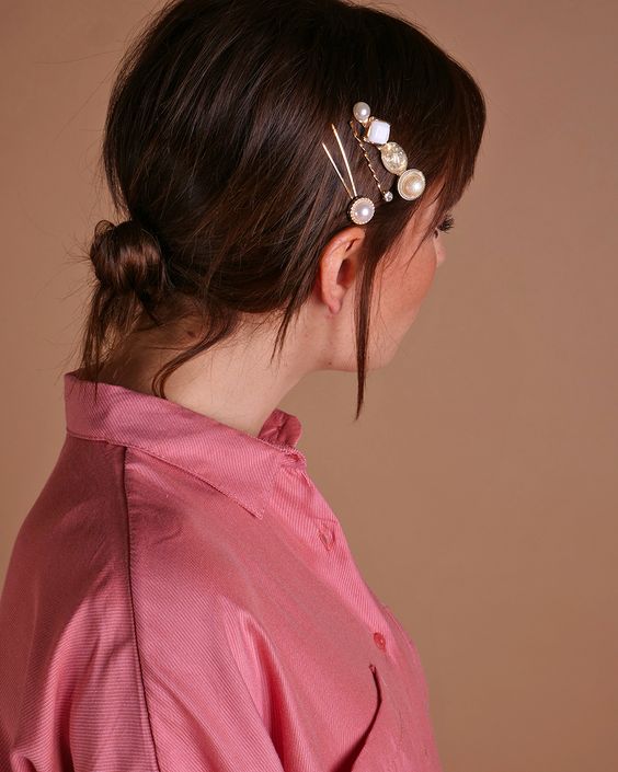 a simple low bun with a sleek top and some beautiful hair pins with pearls and rhinestones is an amazing idea