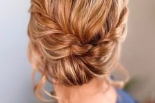 a twisted updo with a braided halo is a catchy and stylish idea for a boho wedding