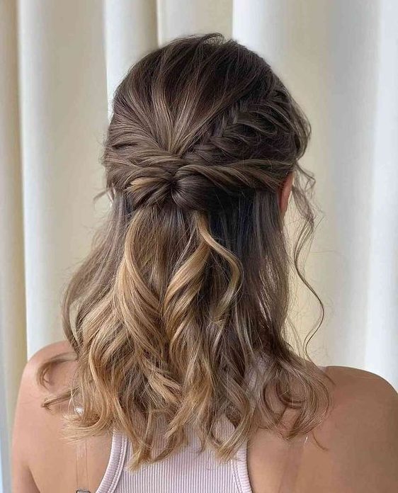 An eye catching boho half updo with a twisted and braided halo, waves down is a stylish idea for medium length hair