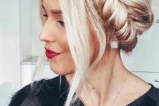 an updo with a pretty fishtail braid halo and face-frmaing locks is a cool and bold idea for the ohlidays if you have long hair