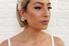 short sleek bob accented with a statement pearl headband and matching earrings for a glam party look