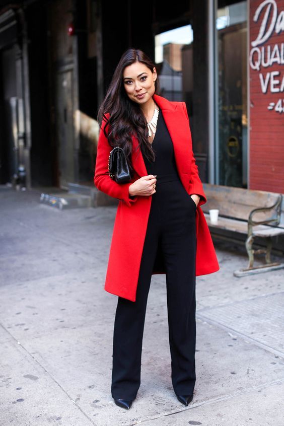 a black jumpsuit, a statement necklace plus a bold red coat is suitable for work