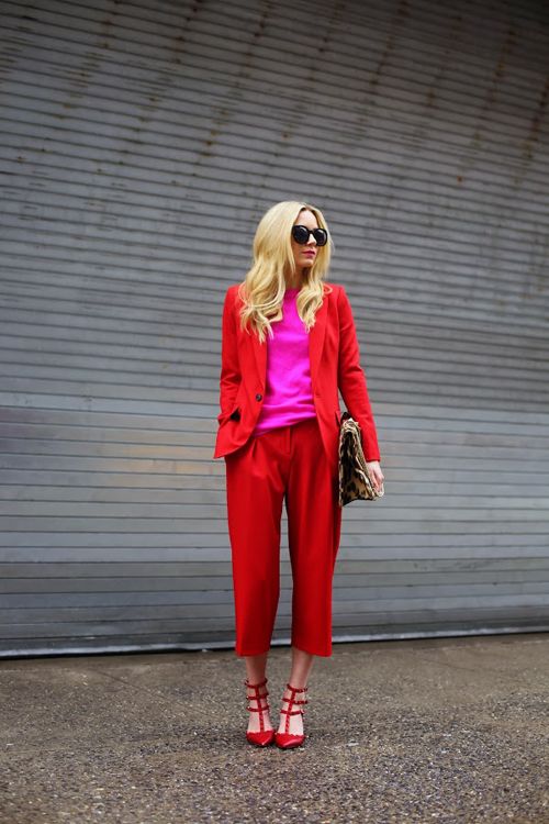 a bold red pantsuit with cropped pants, a pink sweater and red heels for a trendy colorblock look