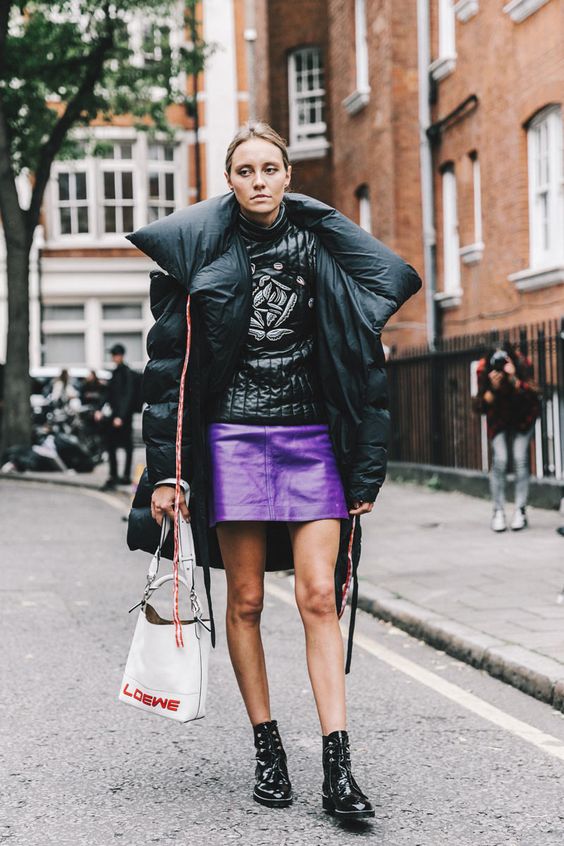 a ultraviolet leather mini skirt, an oversized puffed coat, lacked boots for a trendy winter outfit