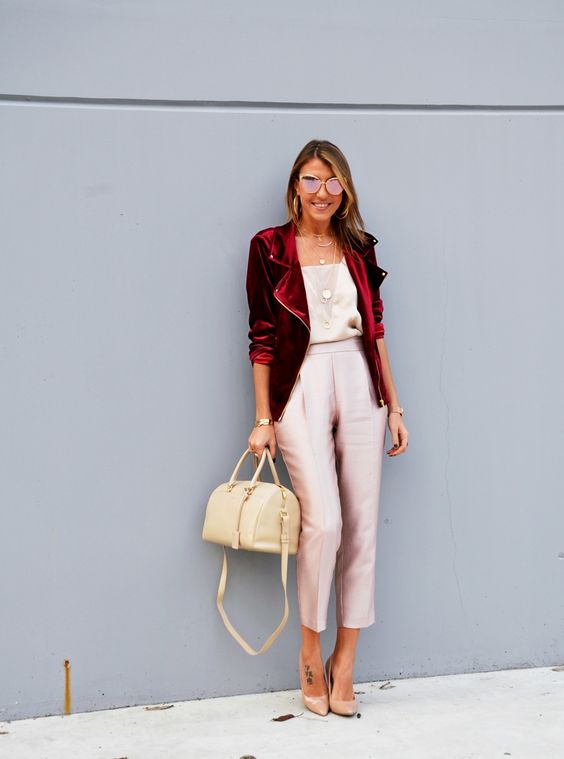 blush cropped pants, a neutral top, a red velvet jacket and nude shoes