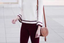 09 grey boots, plum-colored velvet pants, a white sweater with a red trim and a bag