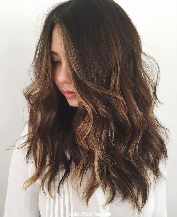 long dark wavy hair with subtle bronded and caramle highlights