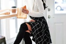 11 a white turtleneck sweater, a black knee windowpane skirt and tall blakc suede boots