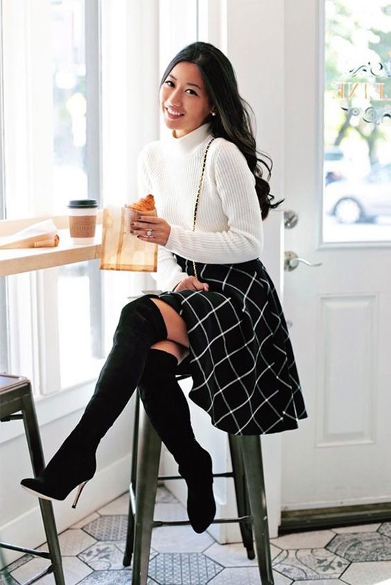 a white turtleneck sweater, a black knee windowpane skirt and tall blakc suede boots
